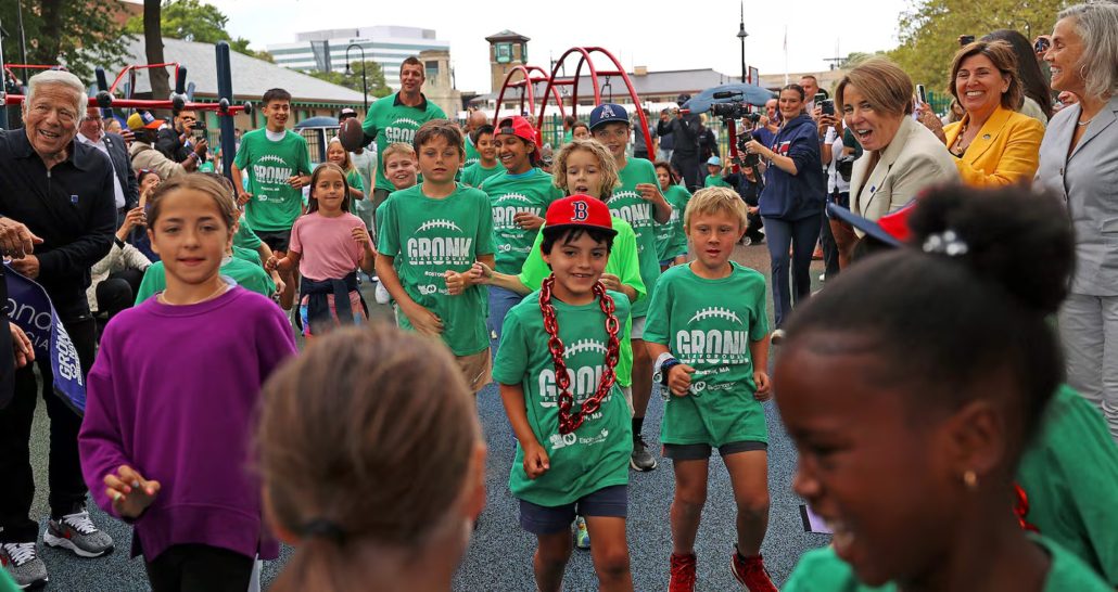 Rob Gronkowski (rear center), with Bob Kraft (on far left) and Governor Maura Healey (far right), celebrated the opening of Gronk Playground — a fully ADA-accessible destination for inclusive play and youth fitness on the Charles River Esplanade.David L Ryan/ Globe Staff