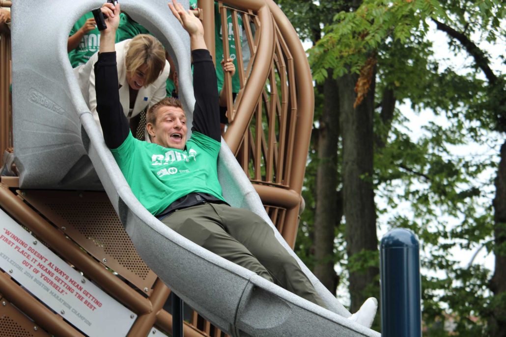 Governor Maura Healey Pushing Rob Gronkowski Down the Football Slide (Photo_ Drew Dobeck)